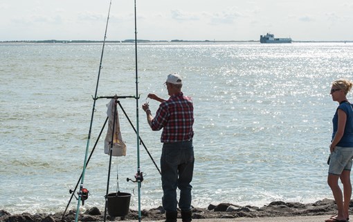 Strand visser man vrouw