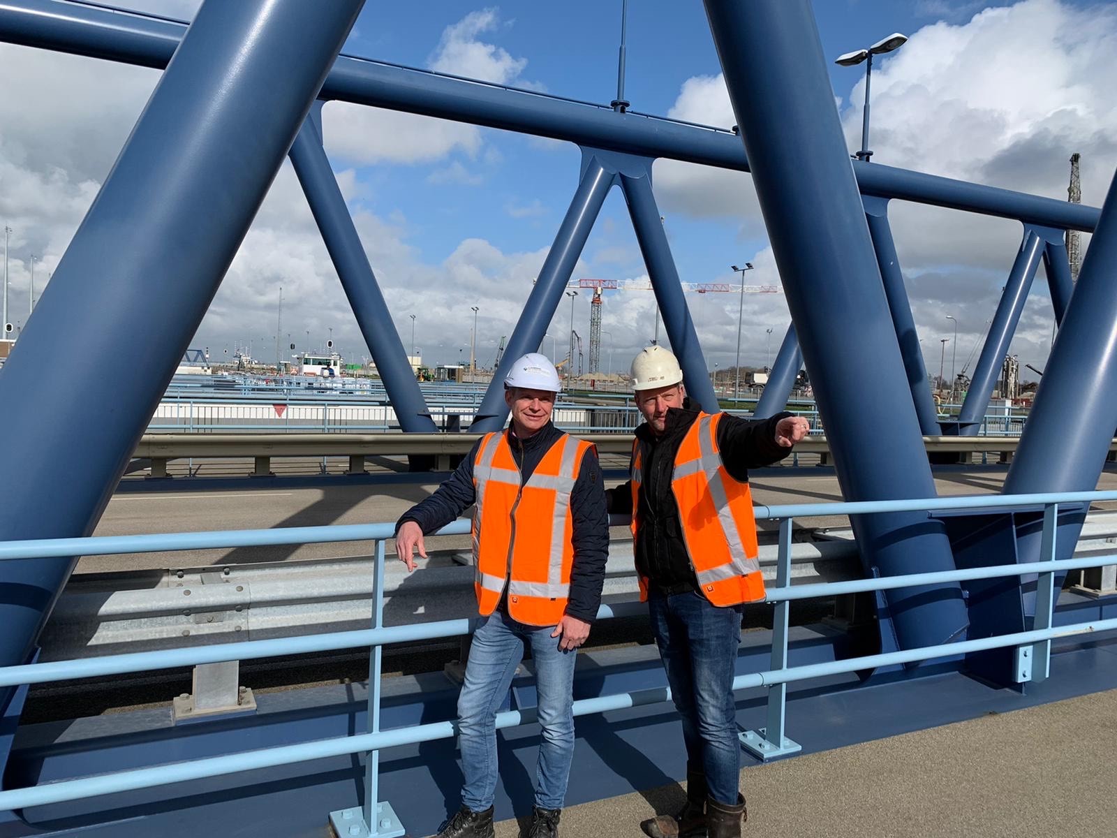 Winnaar Toine met aannemer van der Jagtgroep bij de Nieuwe Sluis Terneuzen met veiligheidshesje en helm